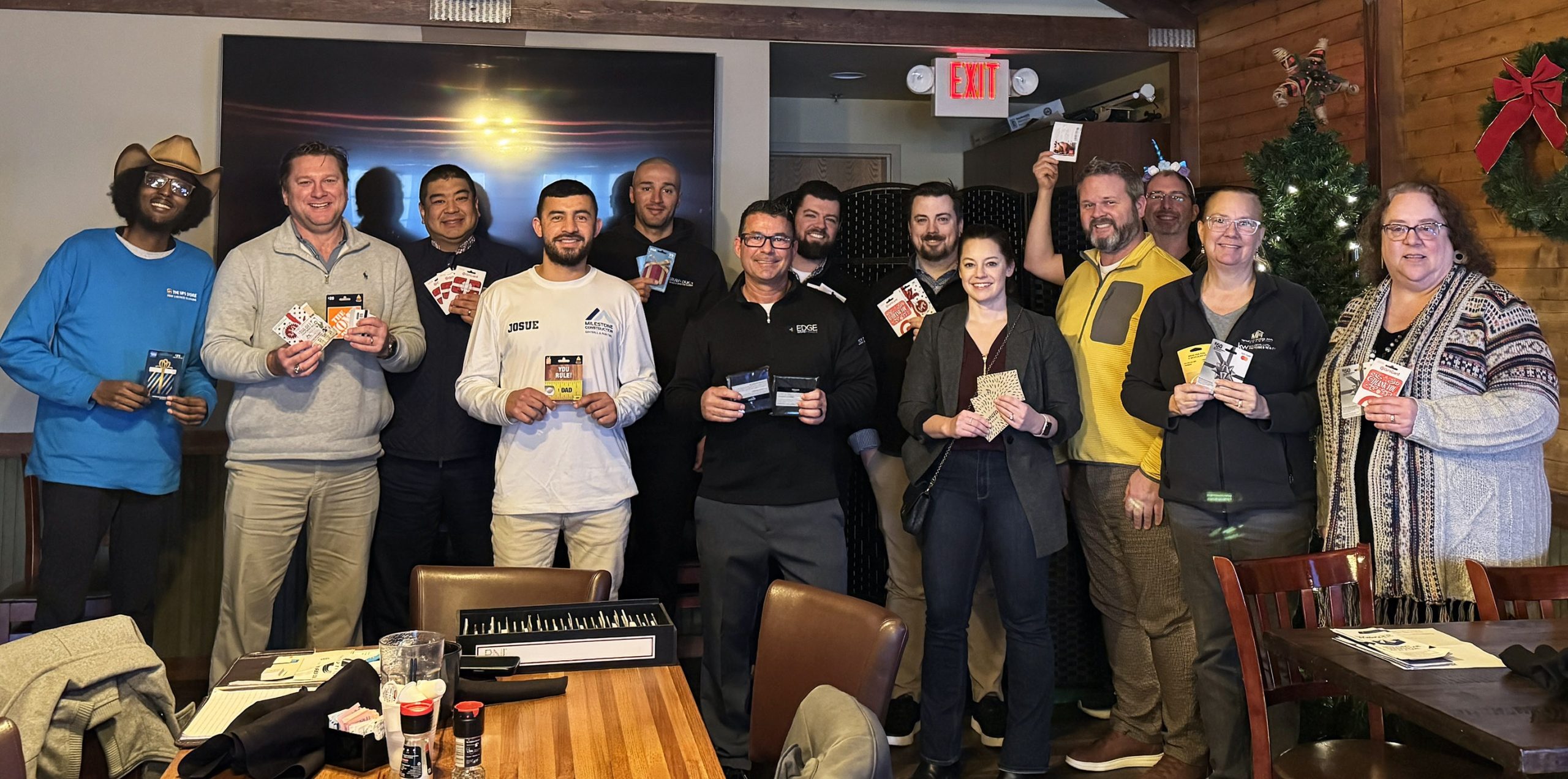 Group of people smiling and holding gift cards